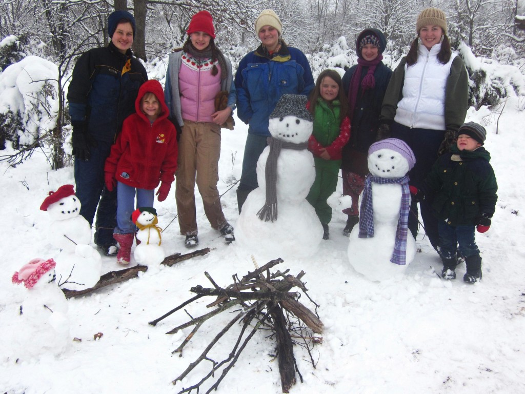 We created a snow family and their campsite! (If you zoom in you can see one or two of them holding marshmallows.) 