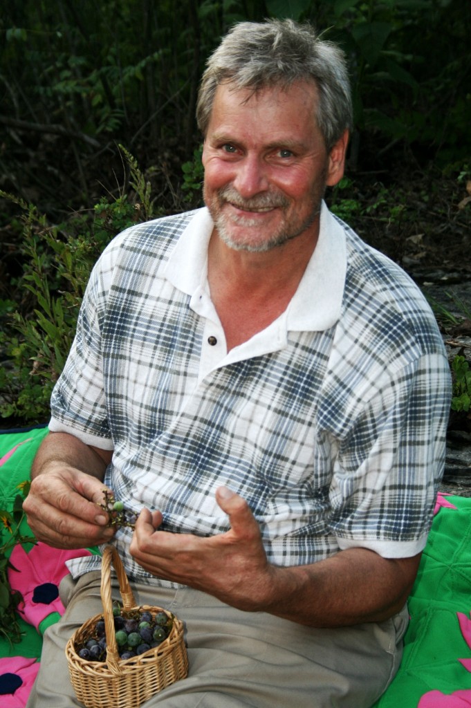 Daddy with his  bunch of fresh picked grapes!