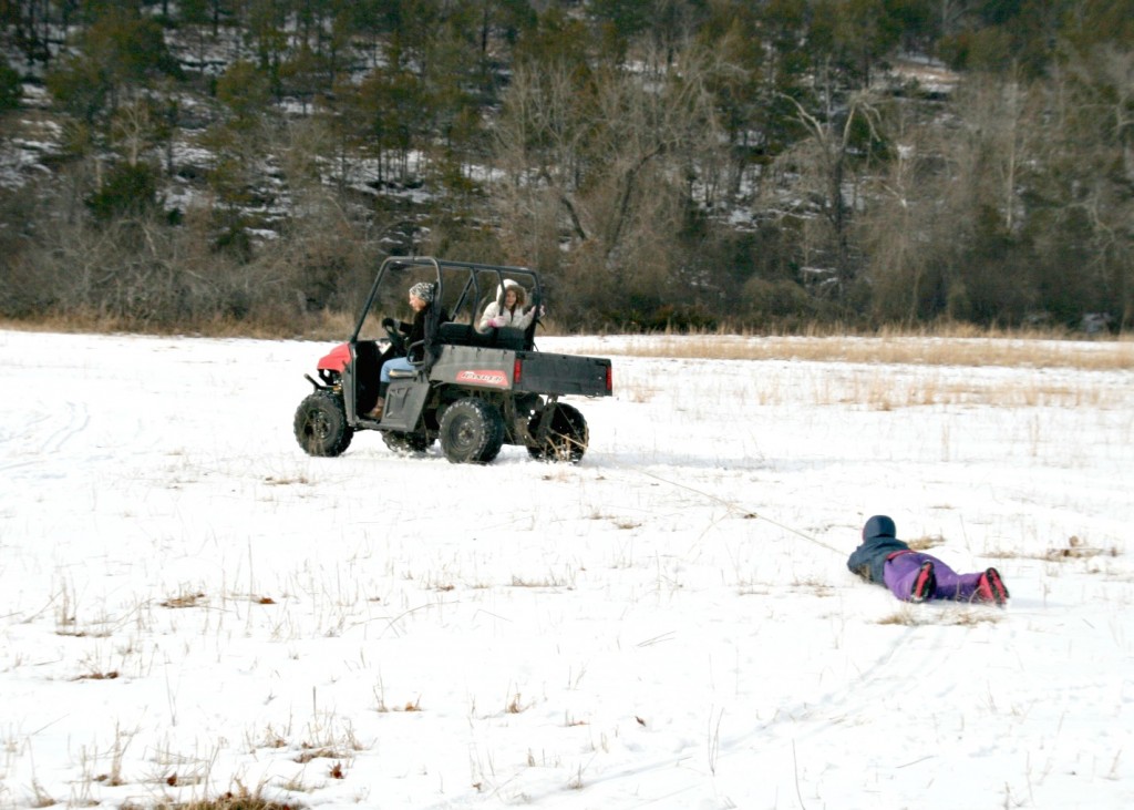 This is one of our favourite winter sports! Someone drives the Polaris, and then the rest of us take turns getting tossed to and fro on some sort of smooth surface. This year we chose a trash bag. 