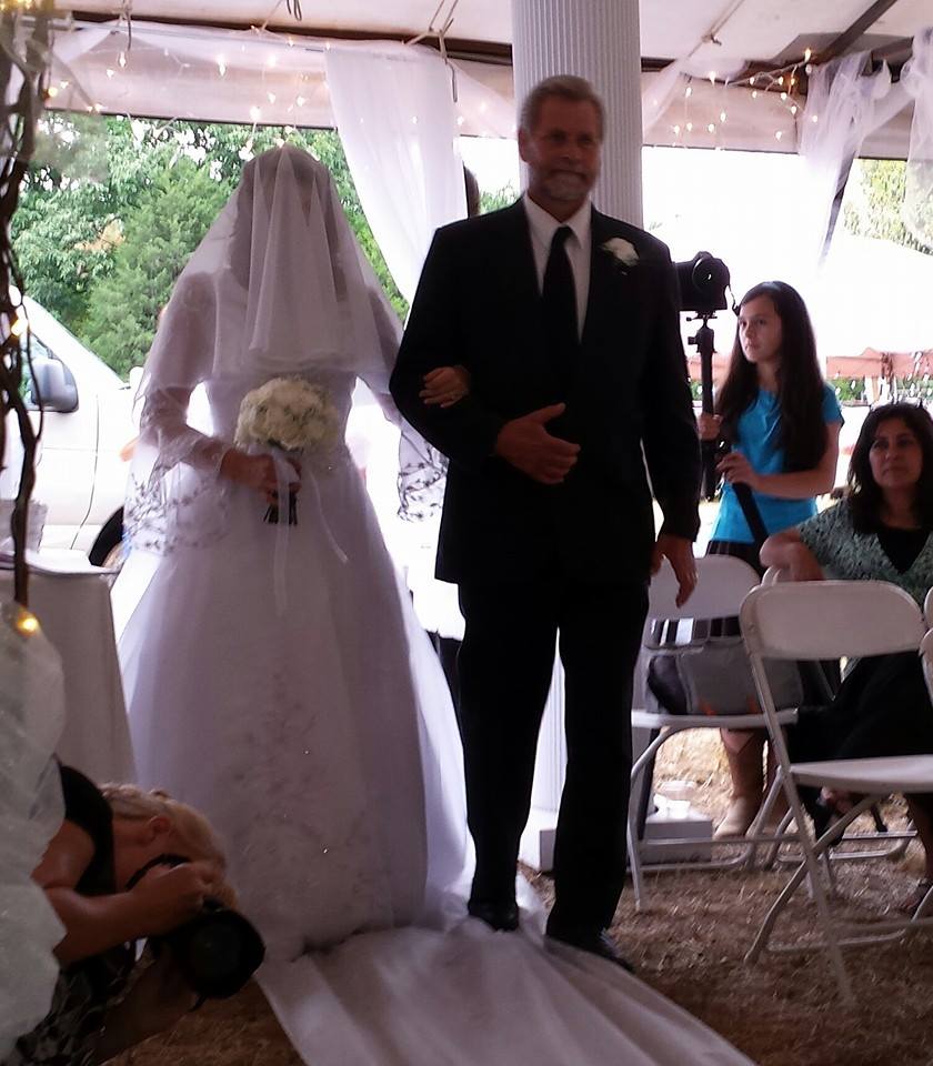 Walking his eldest down the aisle.